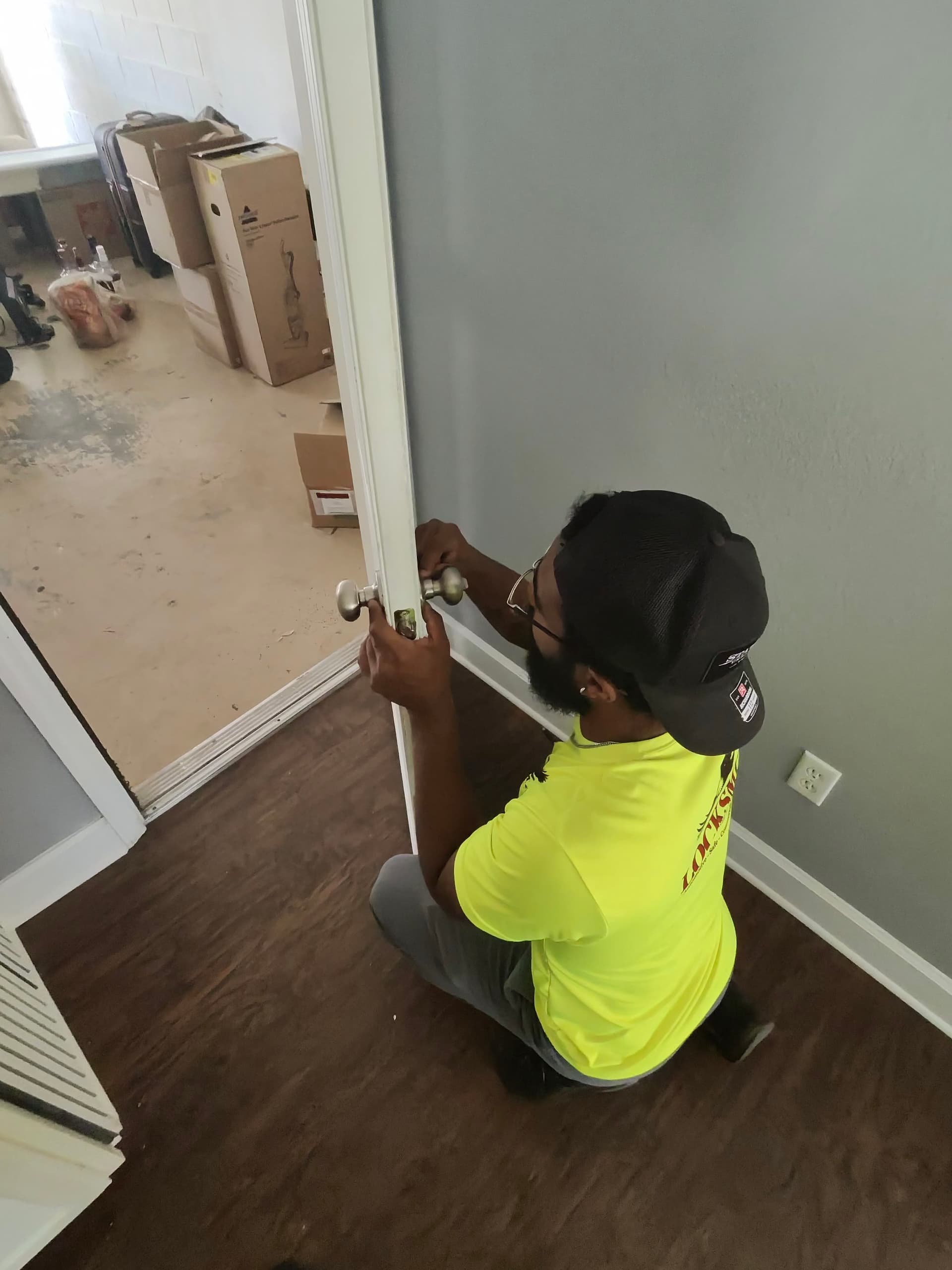 Technician installing a door lock knob – residential locksmith Orlando